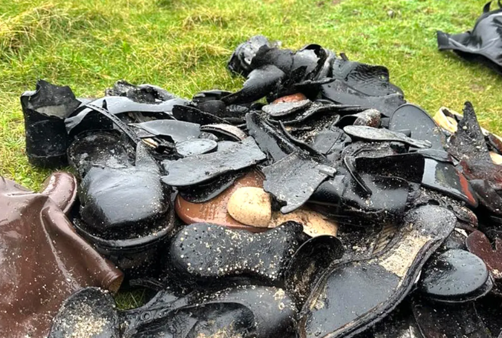Old leather shoes on sea shore