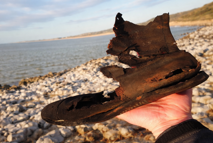 Old leather shoes on beach